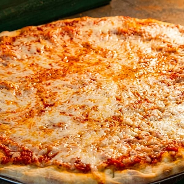 A freshly baked, large cheese pizza with a golden crust and melted mozzarella cheese.